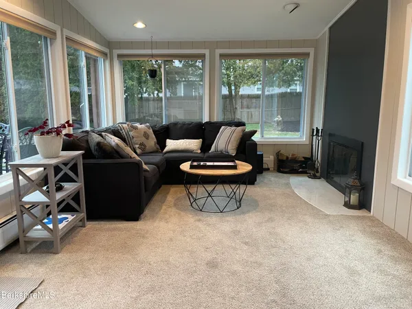 a living room with furniture and a floor to ceiling window