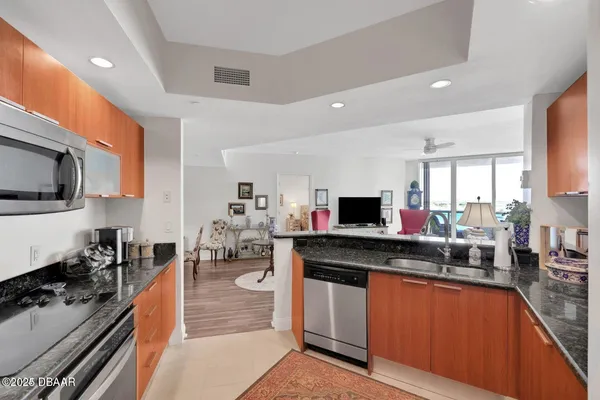 a kitchen with stainless steel appliances granite countertop a stove and a sink