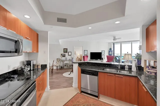 a kitchen with stainless steel appliances granite countertop a stove and a sink