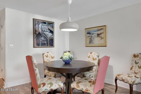 a view of a dining room with furniture and wooden floor