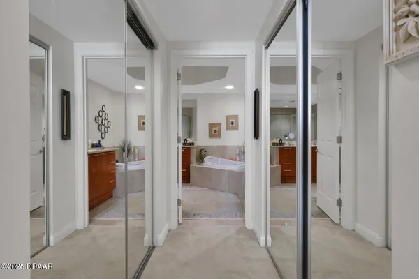 a view of a hallway with a livingroom and a livingroom with furniture