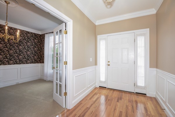 93 Brook Lane, Unit 93 Berlin, MA 01503 - Photo 3 of 29 a view of entryway with window and wooden floor