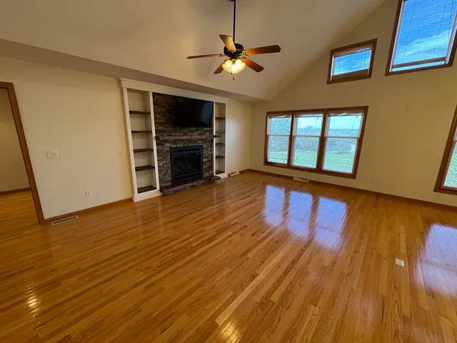 a view of an empty room with wooden floor