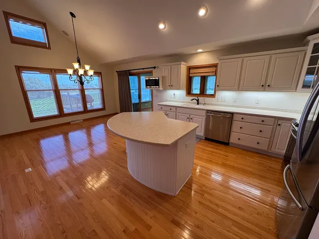 a view of an empty room and wooden floor