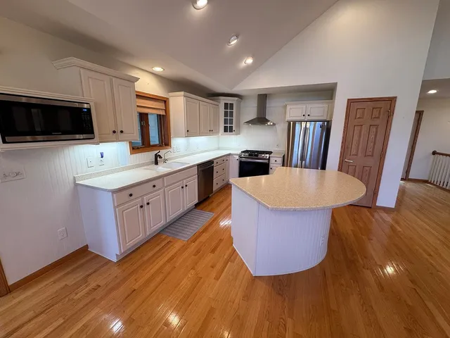 a view of an empty room and wooden floor