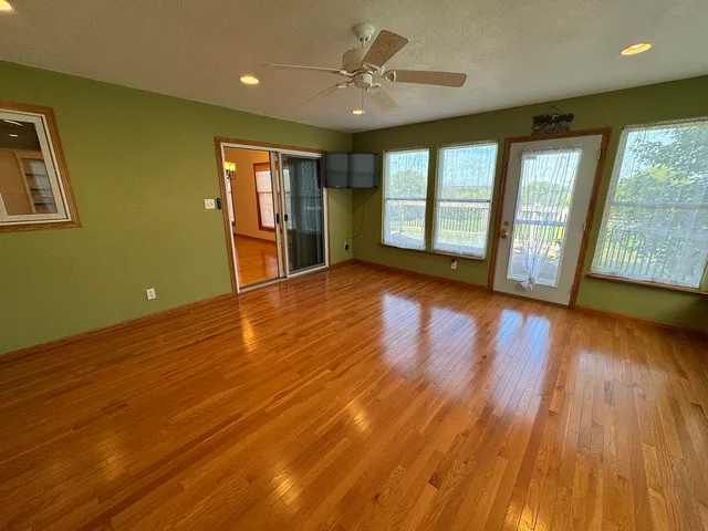 a view of a livingroom with furniture and a flat screen tv