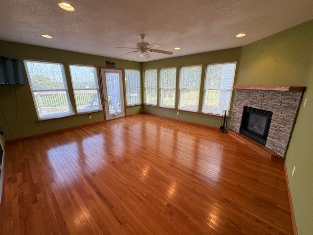 a room with pool table and windows