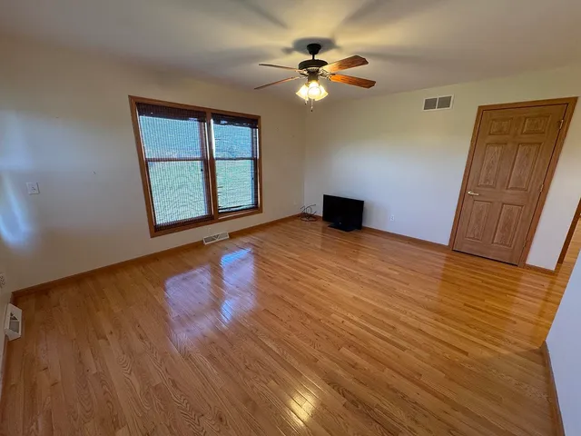 a view of a room with a ceiling fan and a bathroom
