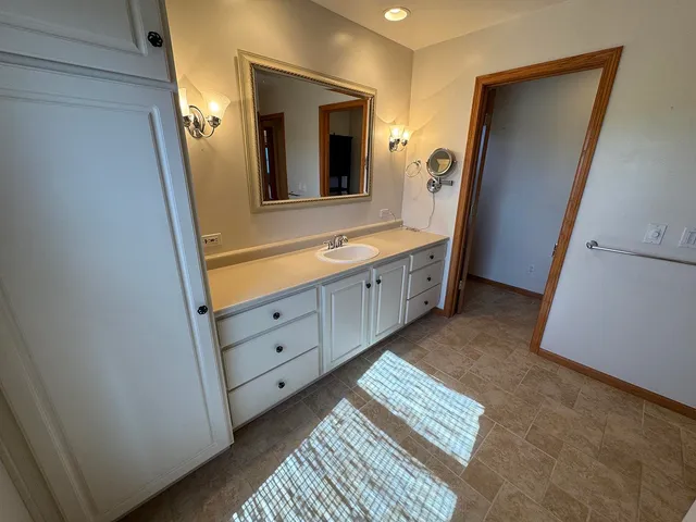 a bathroom with a sink a toilet and mirror