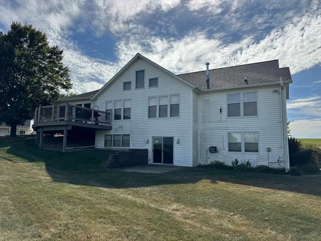 a view of kitchen with sink and refrigerator