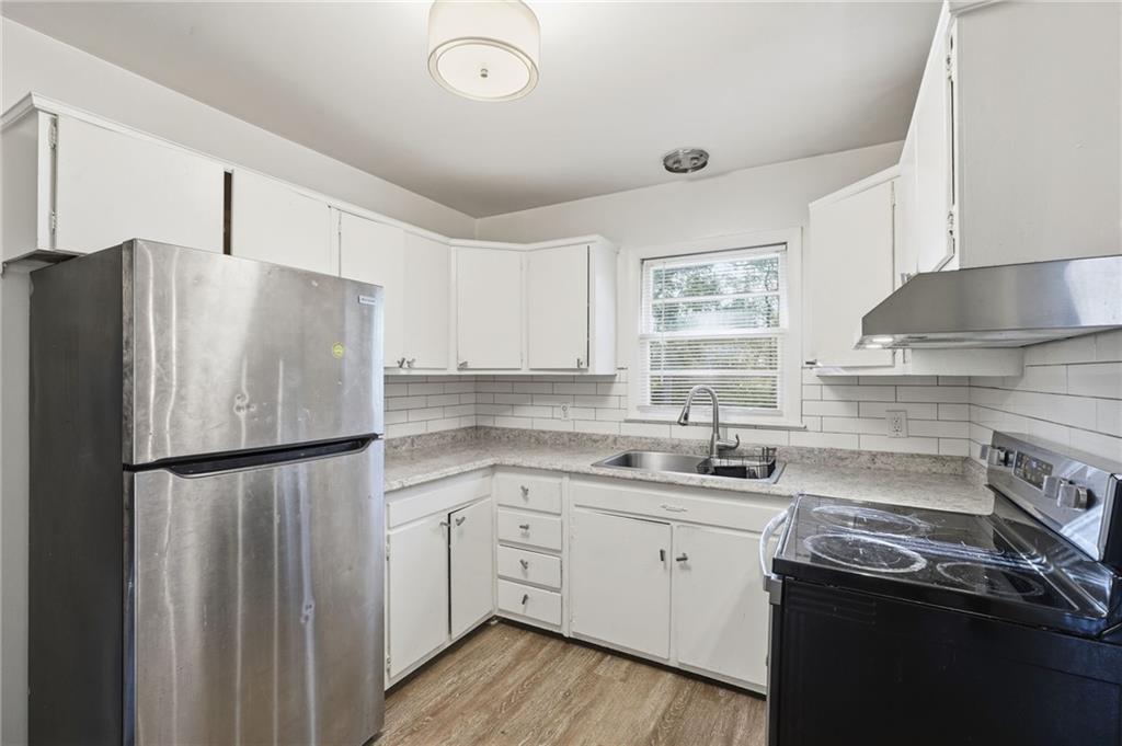 1739 Cardinal Road Hampton, GA 30228 - Photo 11 of 27 a kitchen with a refrigerator sink and cabinets
