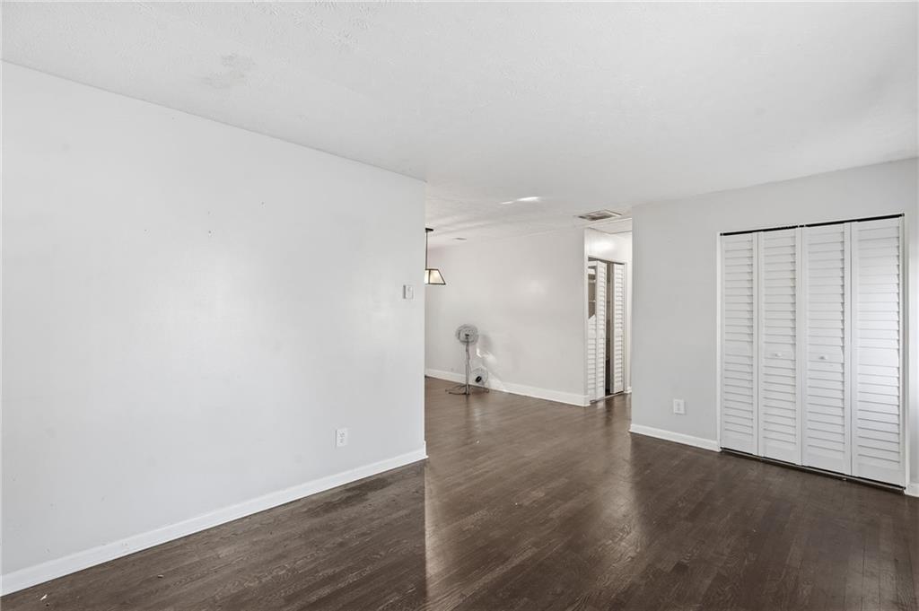 1739 Cardinal Road Hampton, GA 30228 - Photo 16 of 27 an empty room with wooden floor and white walls