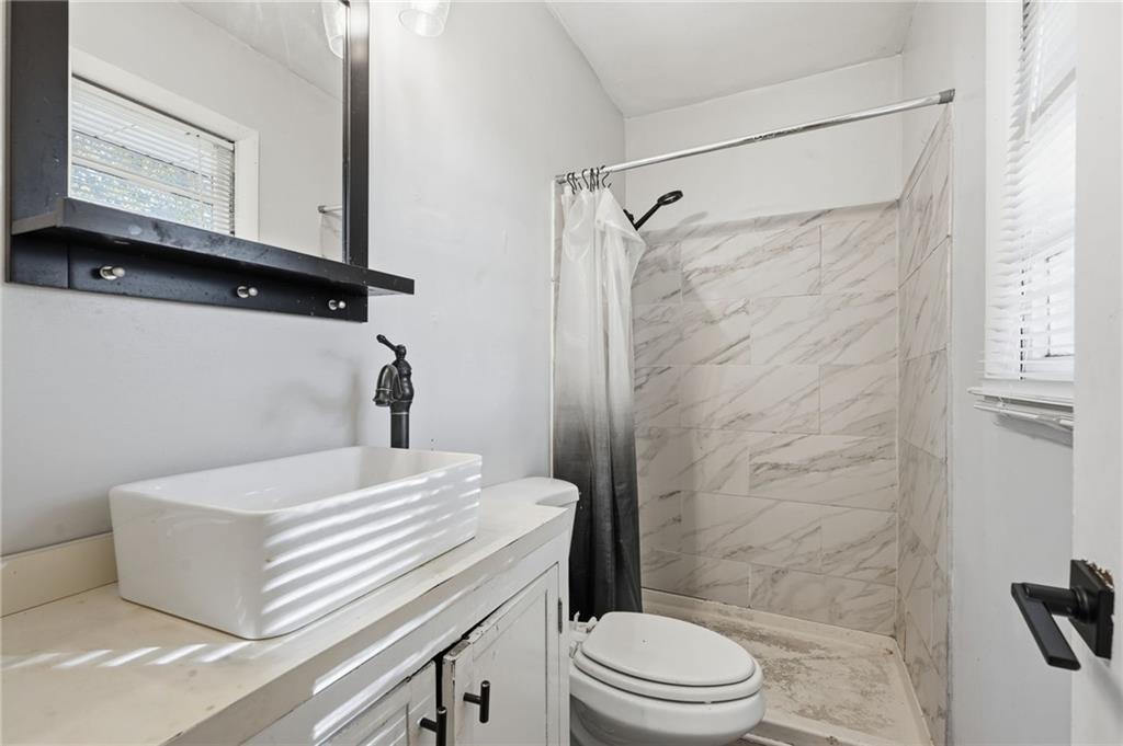 1739 Cardinal Road Hampton, GA 30228 - Photo 21 of 27 a bathroom with a sink a toilet and shower