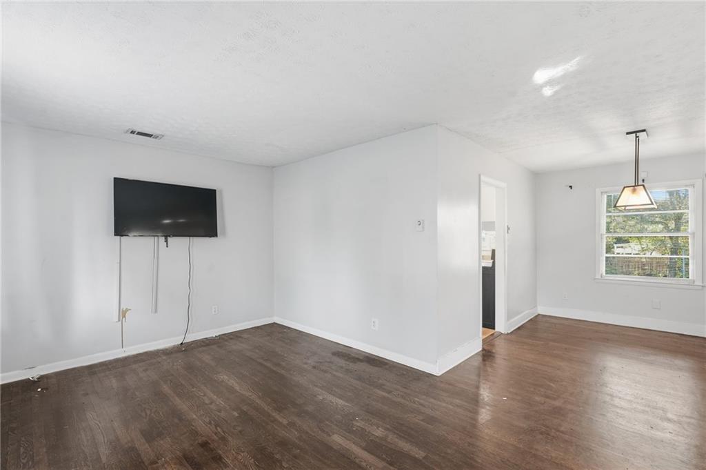 1739 Cardinal Road Hampton, GA 30228 - Photo 5 of 27 an empty room with wooden floor and windows