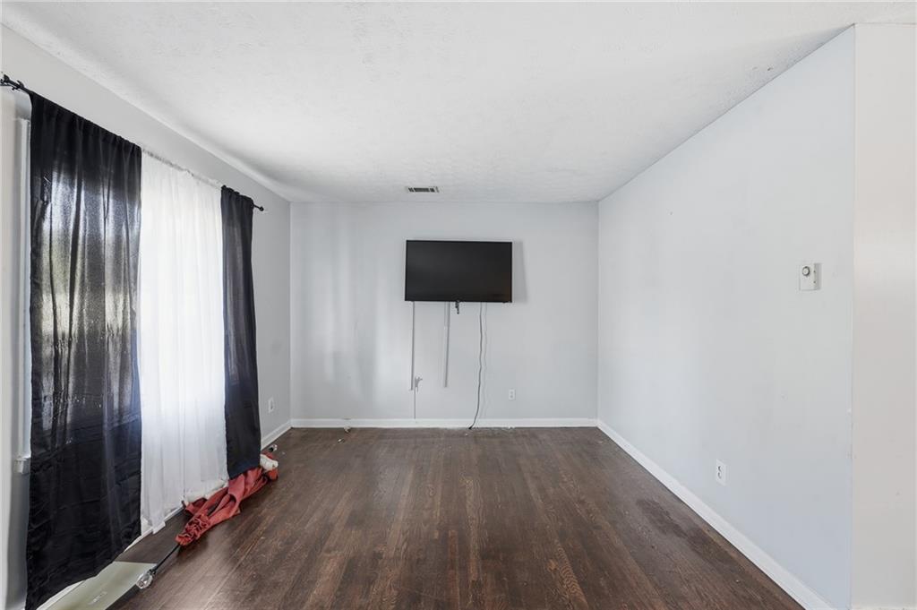 1739 Cardinal Road Hampton, GA 30228 - Photo 6 of 27 an empty room with wooden floor and windows