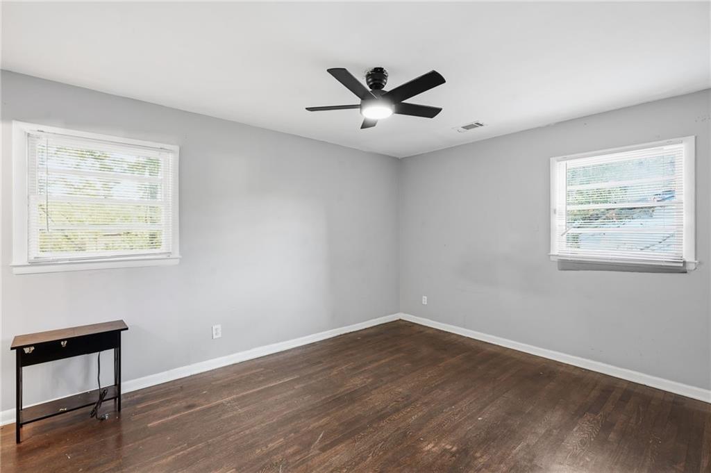 1739 Cardinal Road Hampton, GA 30228 - Photo 7 of 27 a view of an empty room with wooden floor and a window