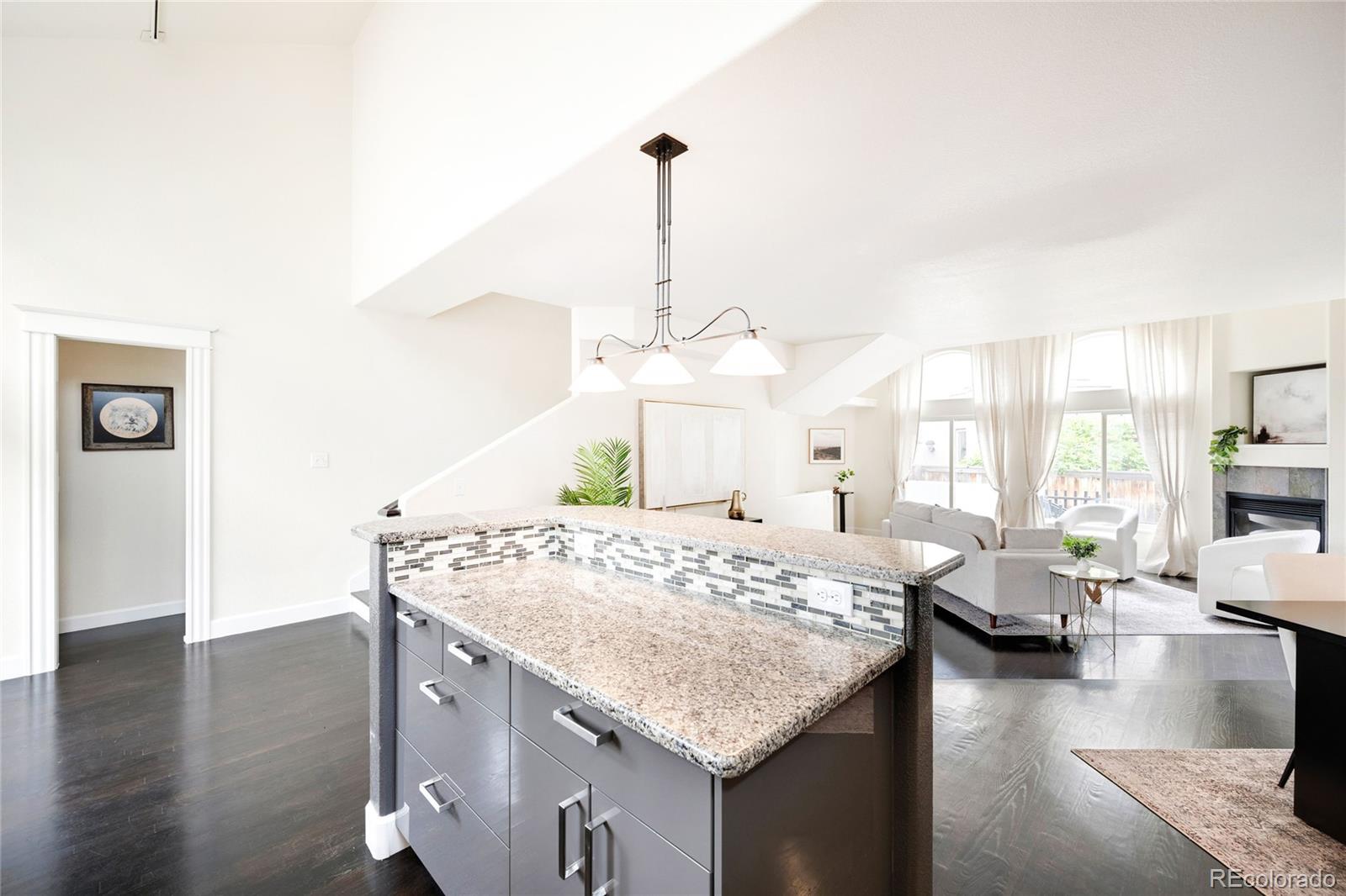 550 Madison Street Denver, CO 80206 - Photo 12 of 39 a living room with dining table and wooden floor