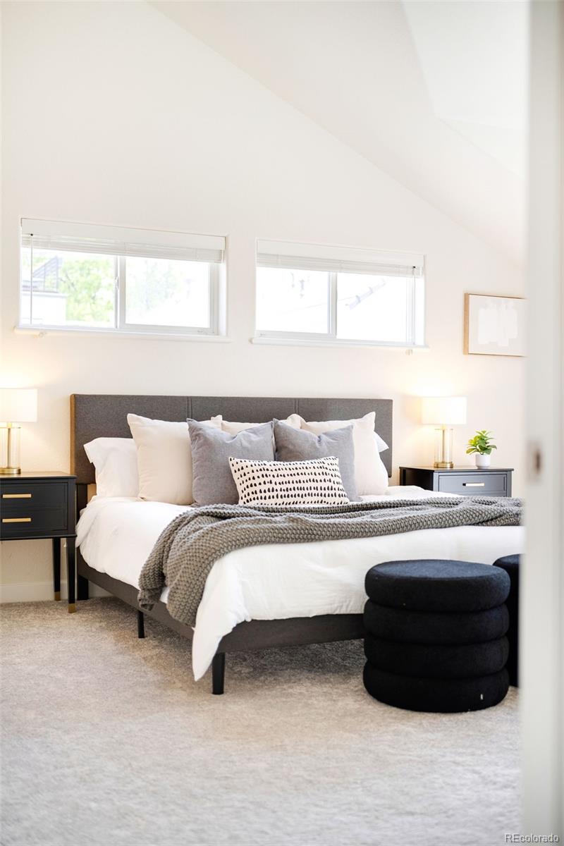 550 Madison Street Denver, CO 80206 - Photo 20 of 39 a bedroom with a bed lamp and a window