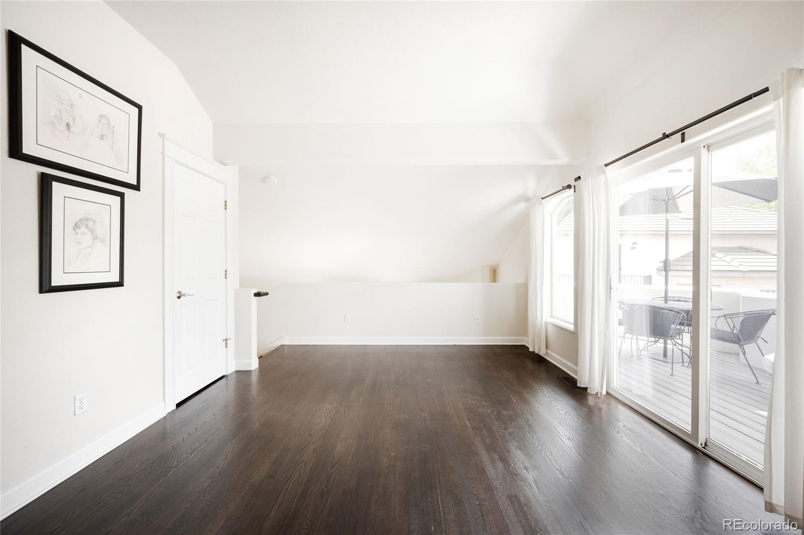 550 Madison Street Denver, CO 80206 - Photo 29 of 39 an empty room with wooden floor and door