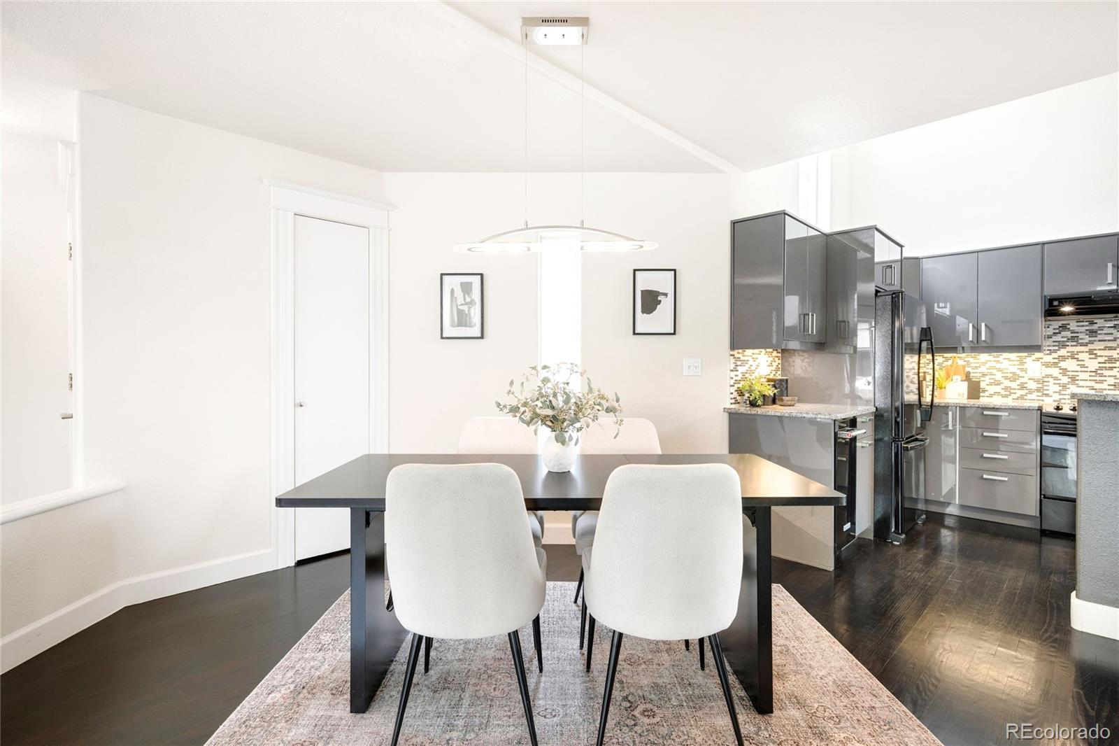 550 Madison Street Denver, CO 80206 - Photo 8 of 39 a view of a dining room with furniture and wooden floor