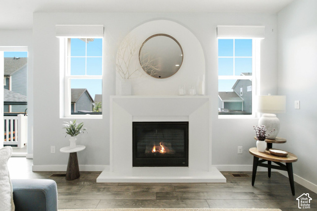 986 South Old Farm Road Heber City, UT 84032 - Photo 9 of 51 Fireplace with an arched mantel, wood-finish flooring, and multiple windows with roller shades