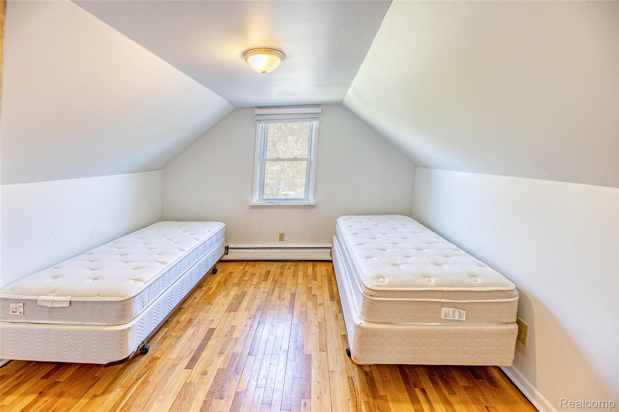 2855 Farmers Creek Road Metamora, MI 48455 - Photo 21 of 51 Attic room featuring sloped ceilings, hardwood flooring, and a single window