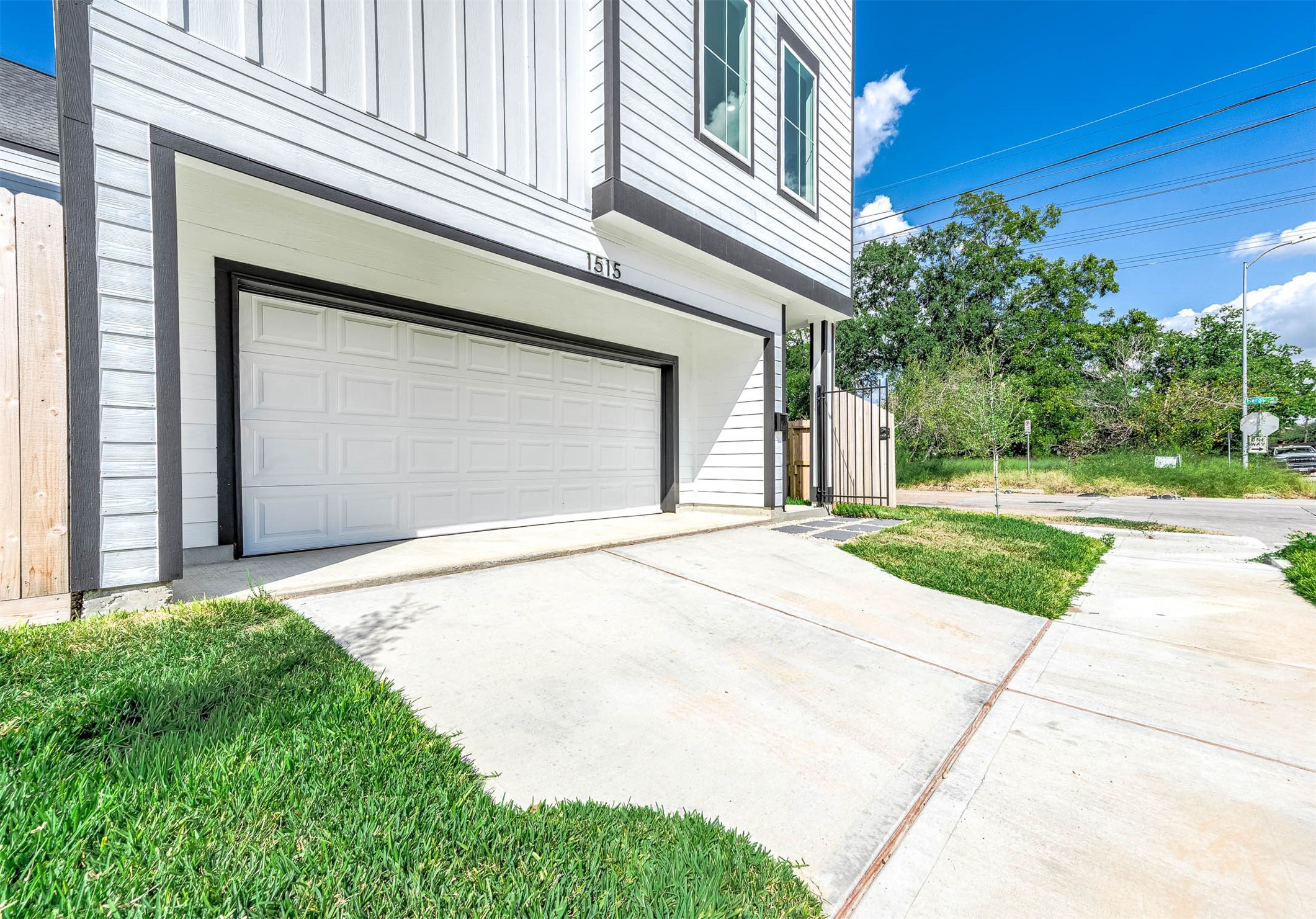 1515 Euel Street Houston, TX 77009 - Photo 4 of 34 Private two-car garage with a wide driveway and contemporary exterior finishes, offering both convenience and polished curb appeal.