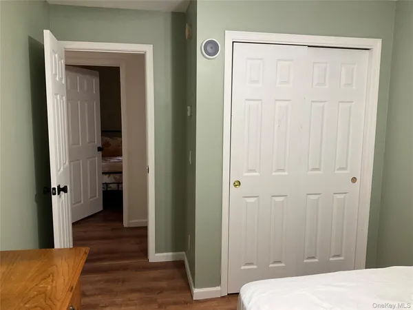 a bedroom with a bed and a mirror