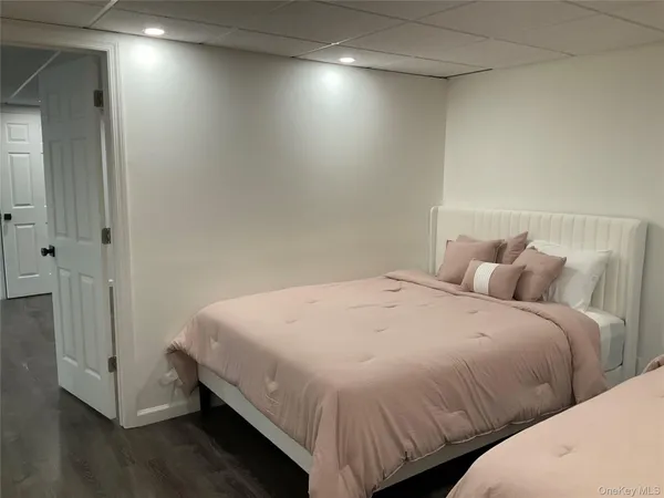 a bedroom with bed and a night stand