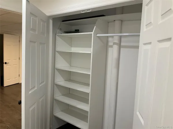 a bed sitting in a bedroom next to a larger window
