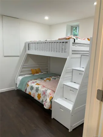 a view of a room with wooden floor and bench