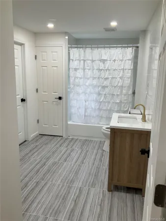 a bed sitting in a bedroom next to a larger window