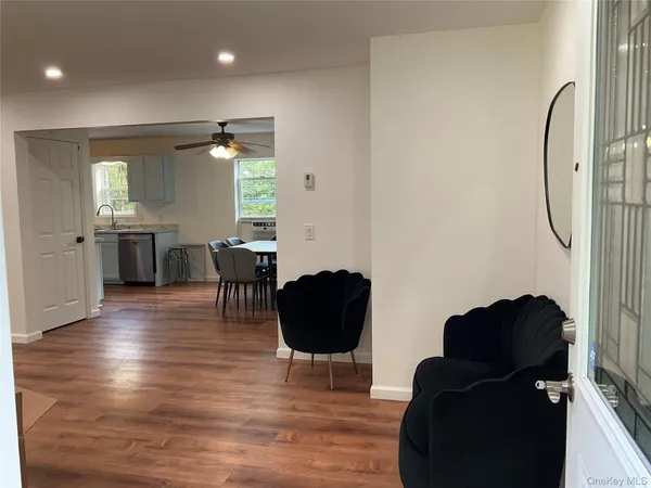 a living room with furniture and a large mirror