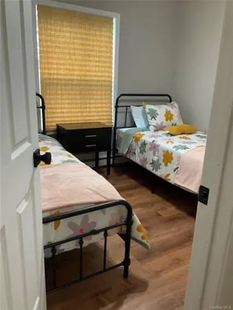 a bedroom with a bed and two windows