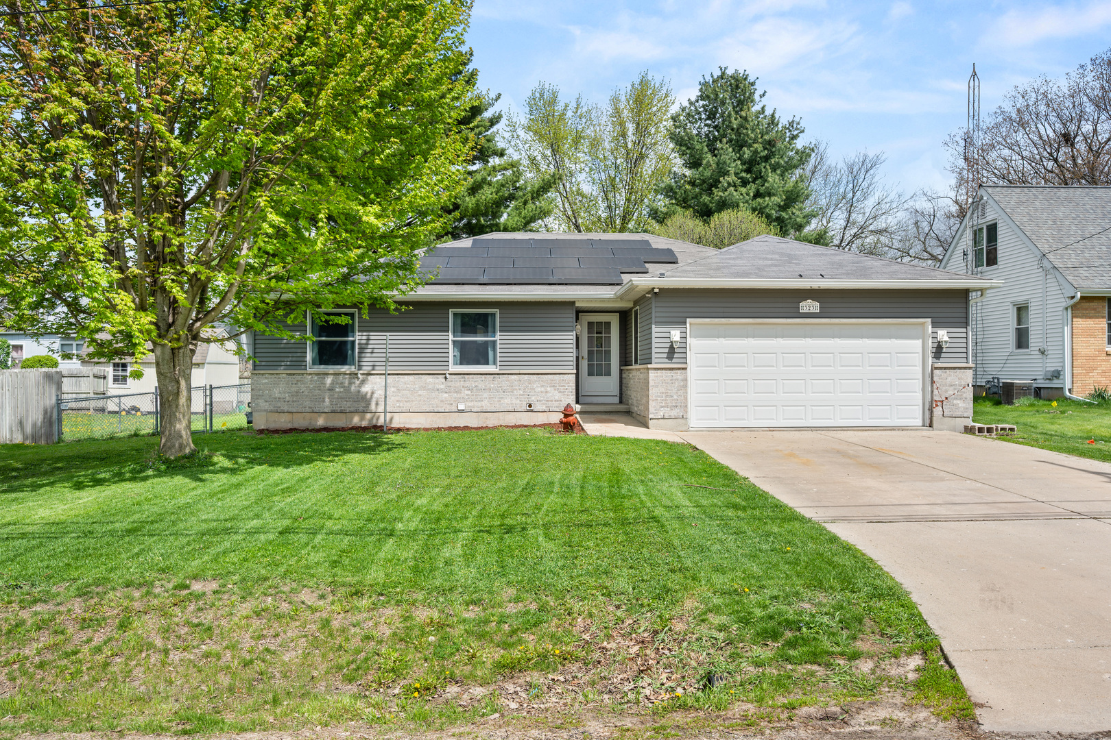 323 West Church Street Genoa, IL 60135 - Photo 1 of 28 a front view of a house with a garden