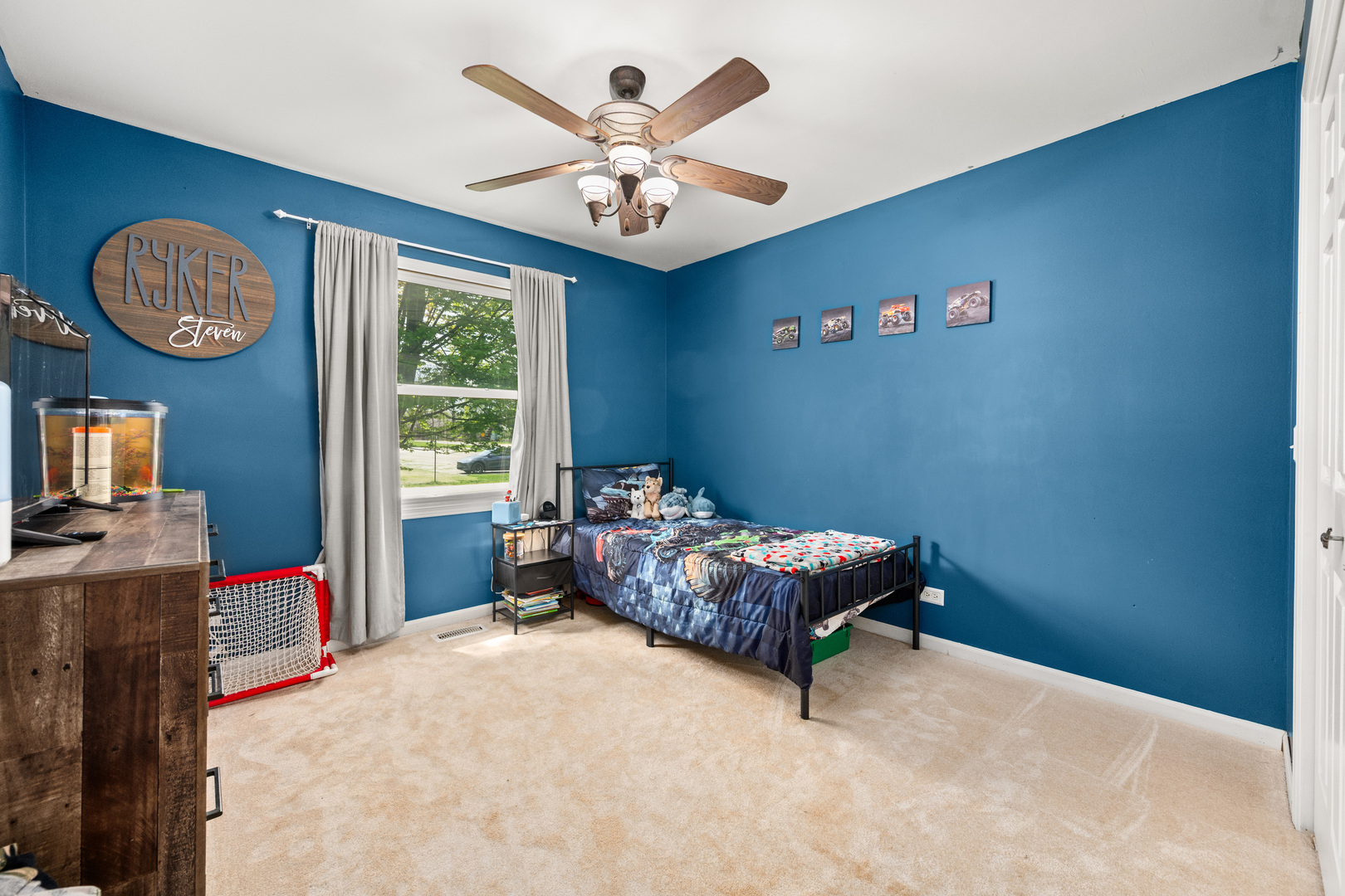 323 West Church Street Genoa, IL 60135 - Photo 12 of 28 a bed room with a bed and a chandelier