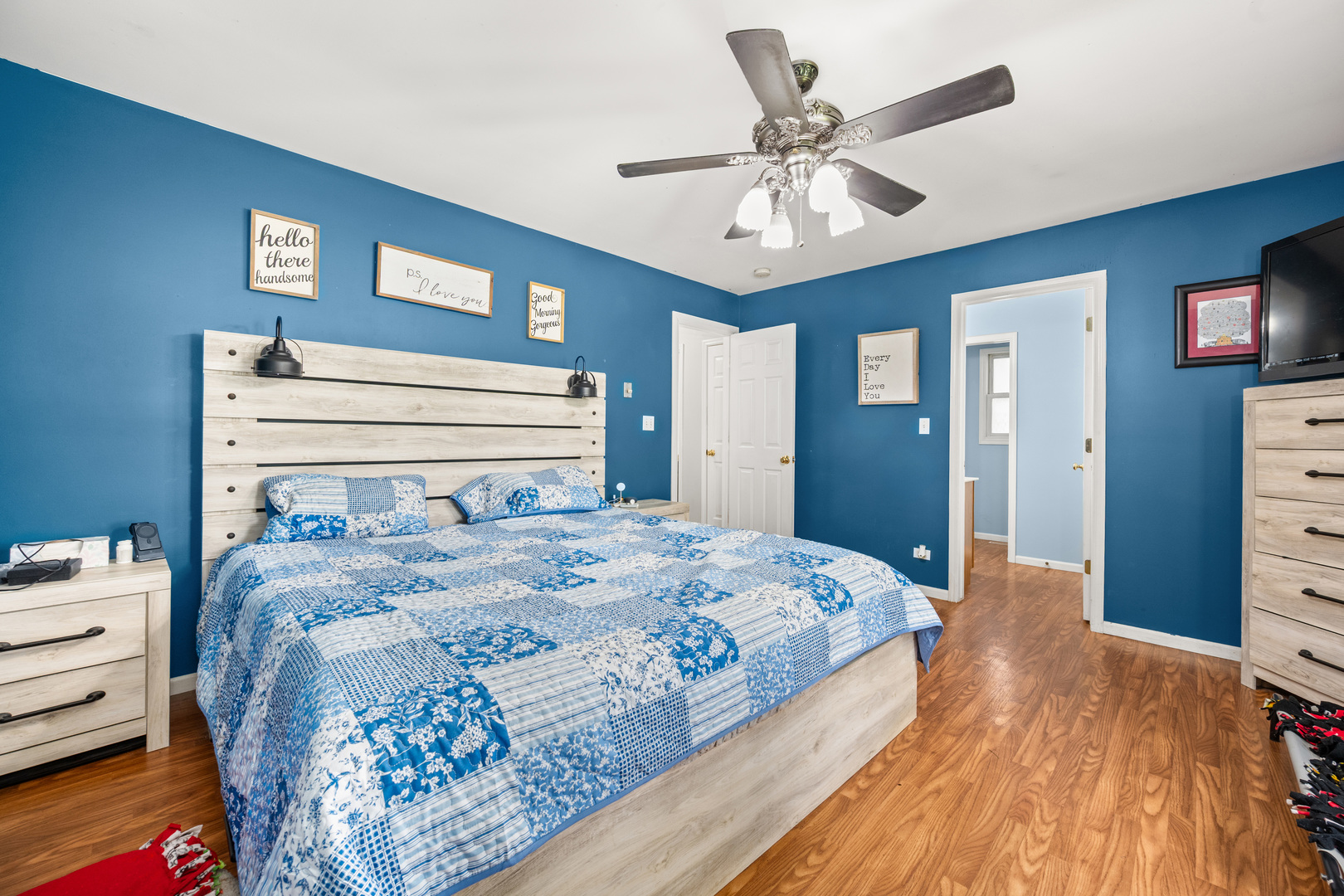 323 West Church Street Genoa, IL 60135 - Photo 16 of 28 a bedroom with a bed and a chandelier