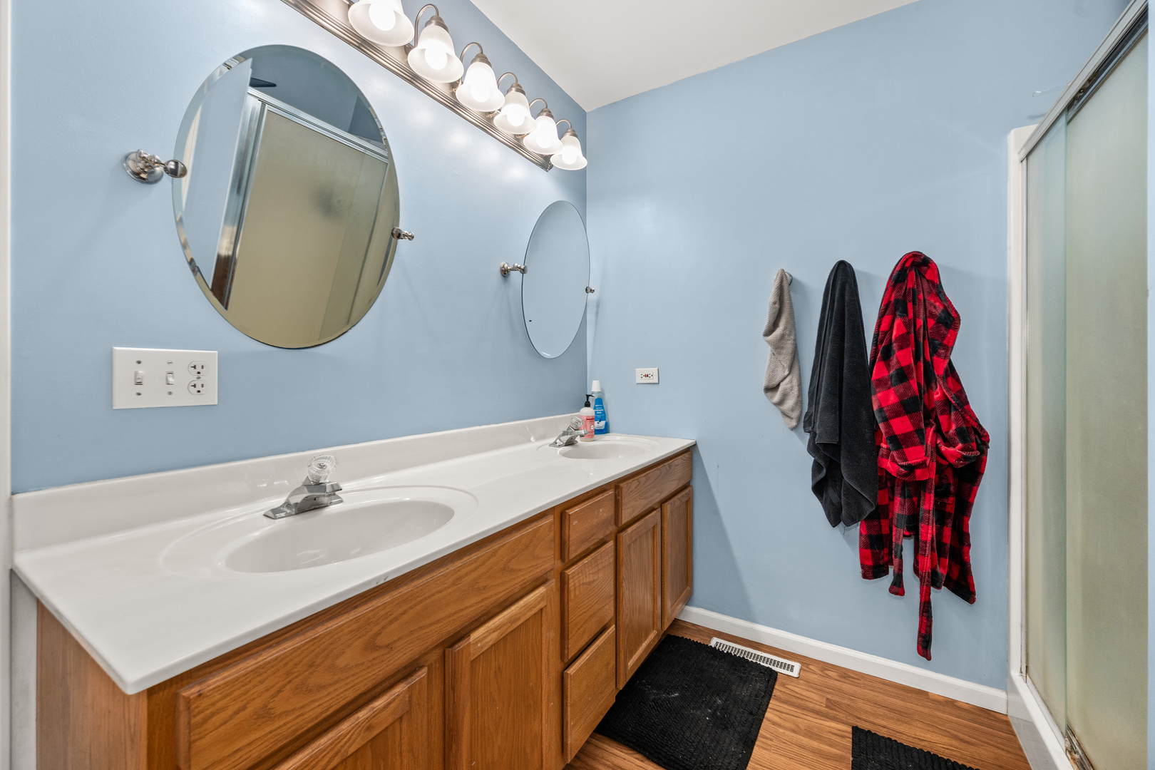 323 West Church Street Genoa, IL 60135 - Photo 18 of 28 a bathroom with a sink vanity and a mirror