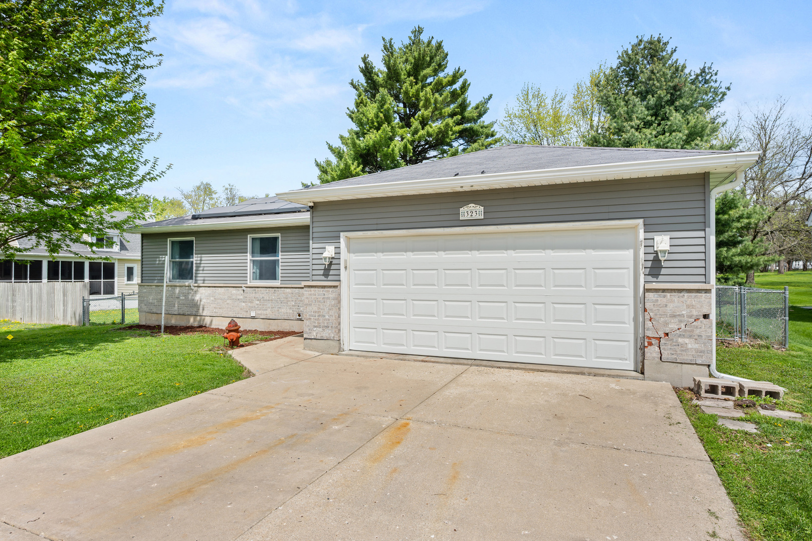 323 West Church Street Genoa, IL 60135 - Photo 2 of 28 a view of a house with a yard and garage