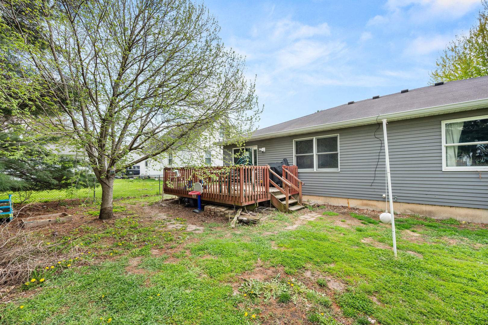323 West Church Street Genoa, IL 60135 - Photo 22 of 28 a view of a house with backyard and a tree