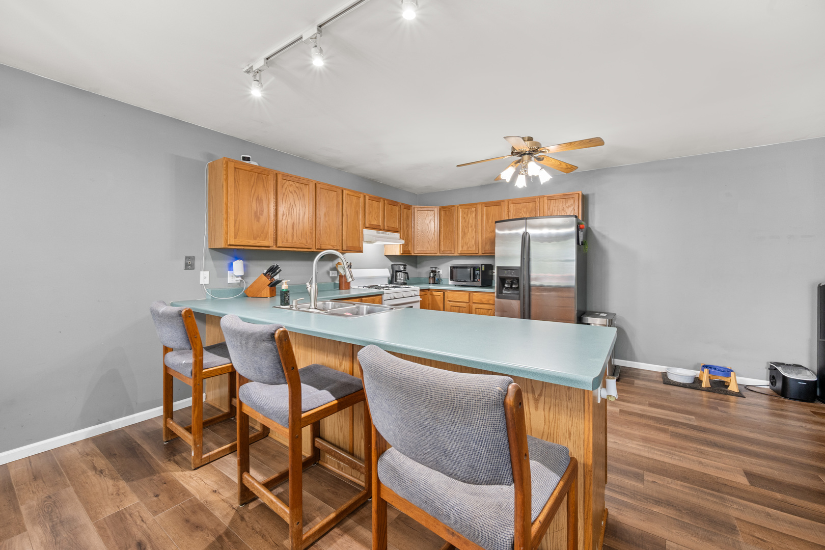323 West Church Street Genoa, IL 60135 - Photo 9 of 28 a dining room with a table chairs and a kitchen view