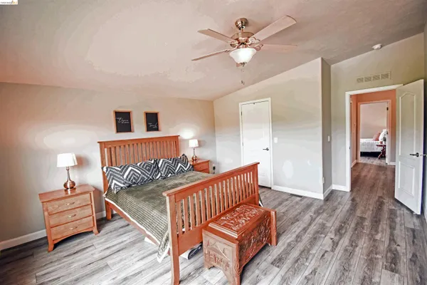 a bedroom with furniture and wooden floor