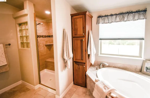 a bathroom with a tub sink and shower