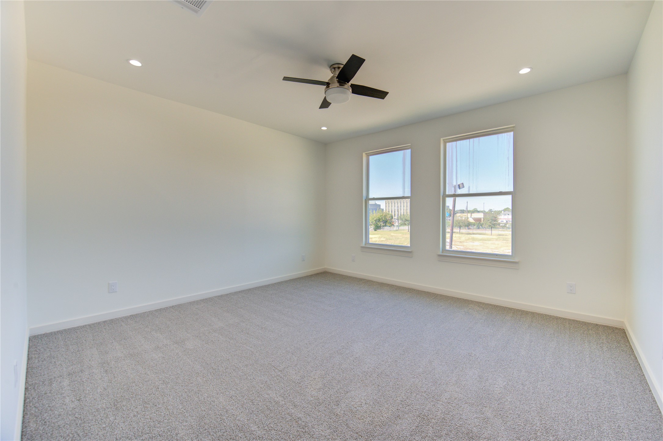 2930 El Fenice Lane Houston, TX 77057 - Photo 15 of 37 an empty room with windows and ceiling fan