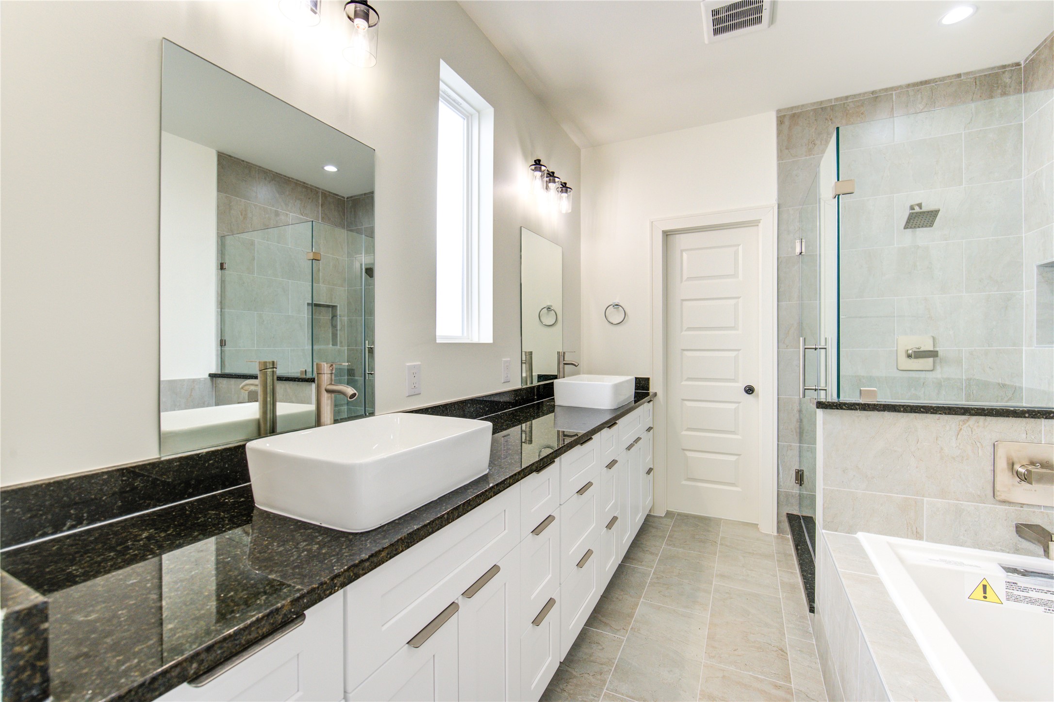 2930 El Fenice Lane Houston, TX 77057 - Photo 20 of 37 a bathroom with a granite countertop double vanity sink a mirror and a bathtub