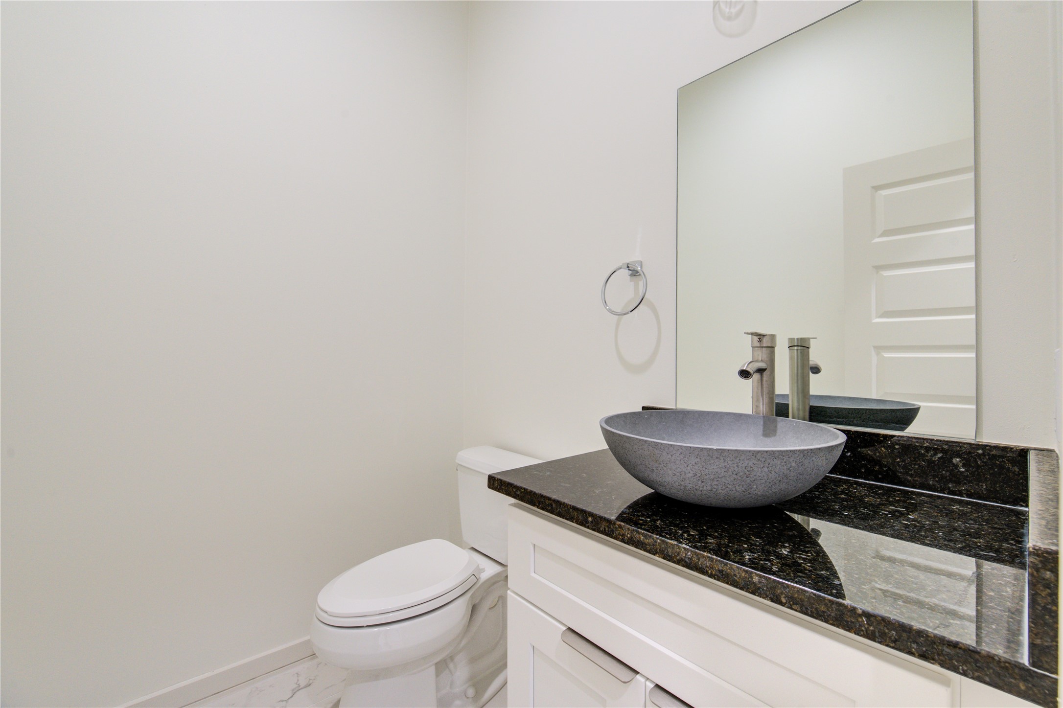 2930 El Fenice Lane Houston, TX 77057 - Photo 25 of 37 a bathroom with a granite countertop toilet and a sink