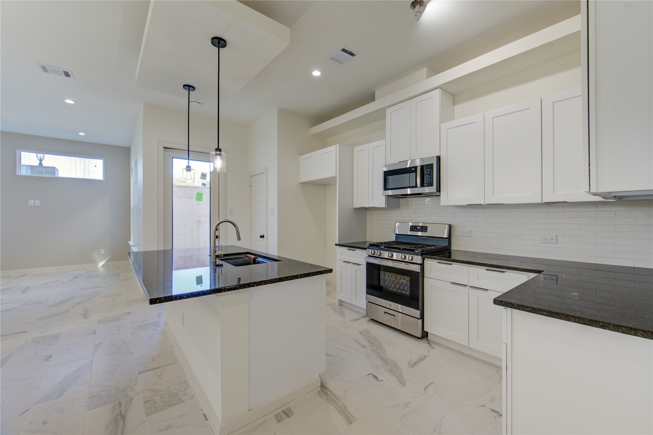2930 El Fenice Lane Houston, TX 77057 - Photo 3 of 37 a kitchen with stainless steel appliances granite countertop a sink a stove a refrigerator and a granite counter tops