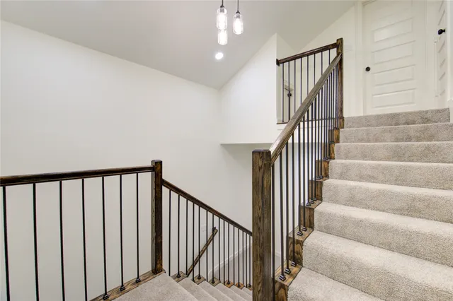 a view of staircase with lots of frames on wall