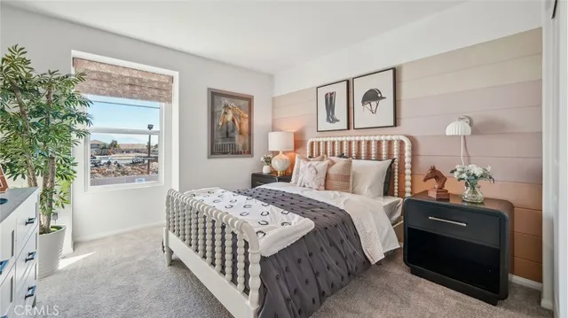 a bedroom with a bed and a painting on the wall