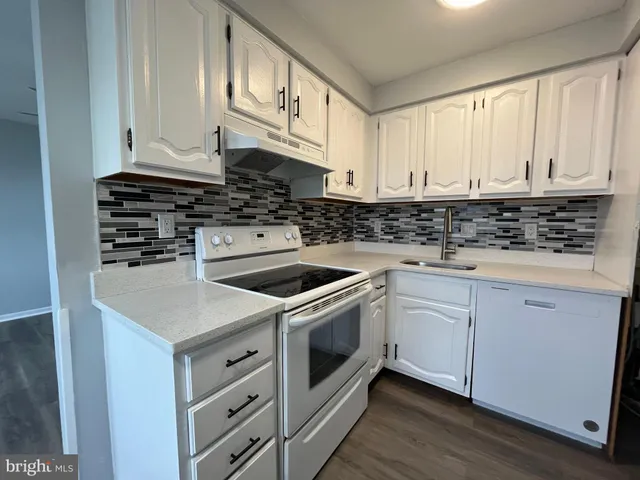 a view of a hallway with wooden floor and closet